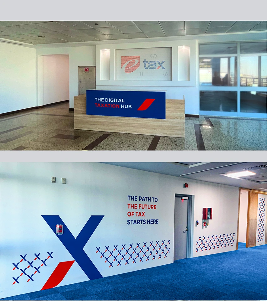 e-Tax reception desk branding and blue wall graphic in the office corridor